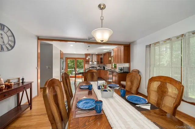 a view of a dining room with furniture a chandelier and wooden floor