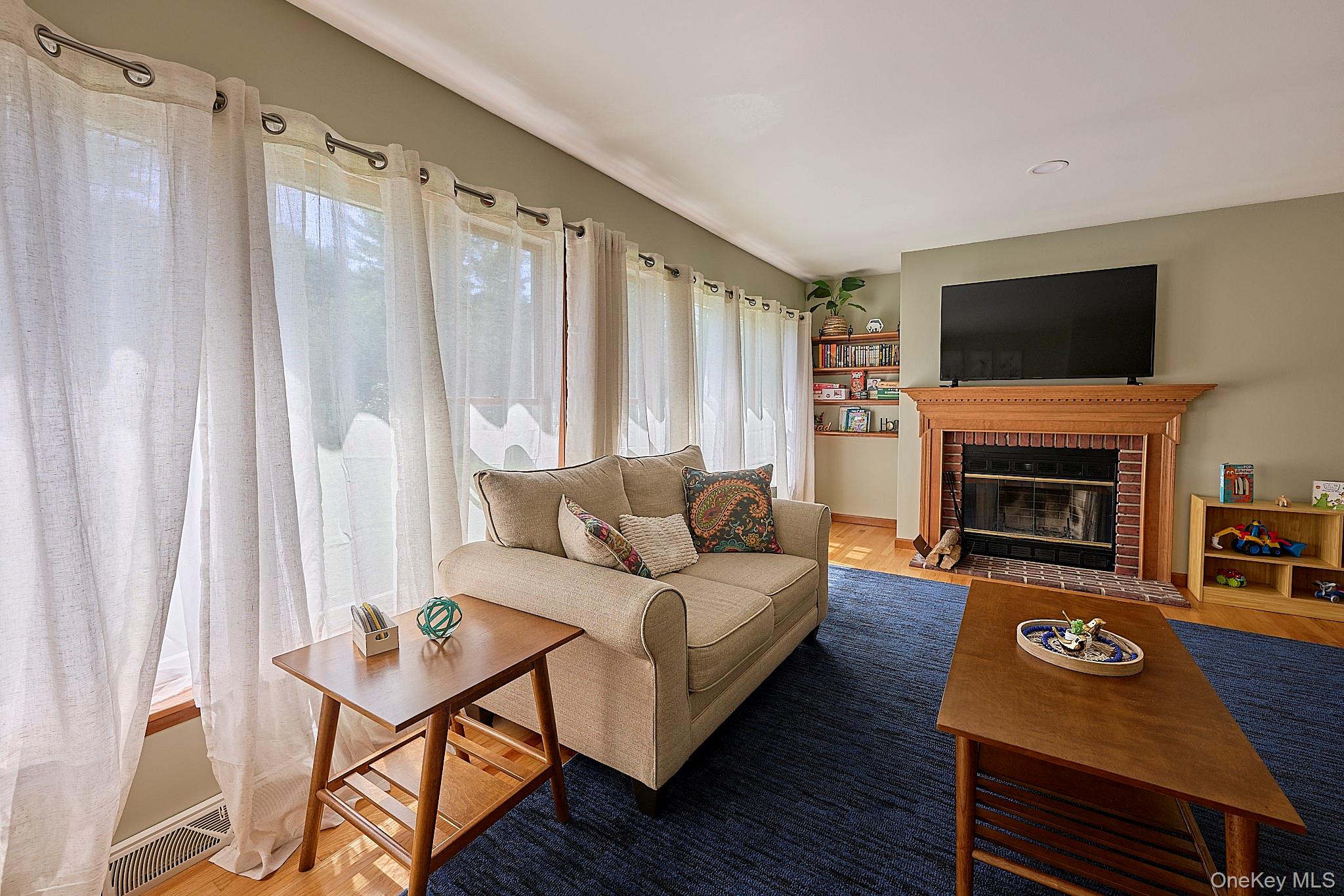 39 Pitio Road Glen Spey, NY 12737 - Photo 30 of 50 a living room with furniture a flat screen tv and a fireplace