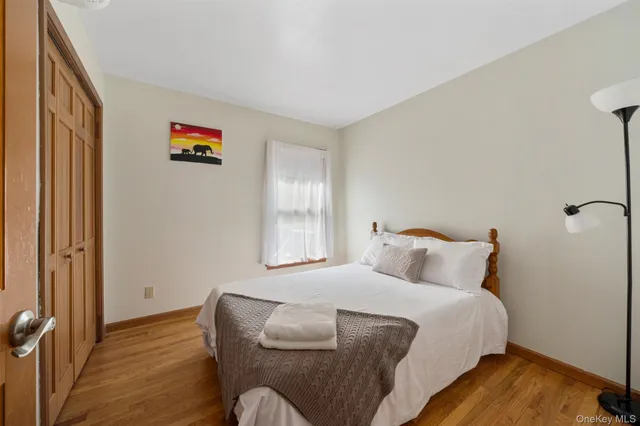 a view of a hallway with wooden floor and windows