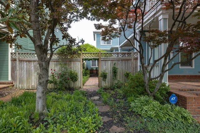 a backyard of a house with lots of green space and fountain