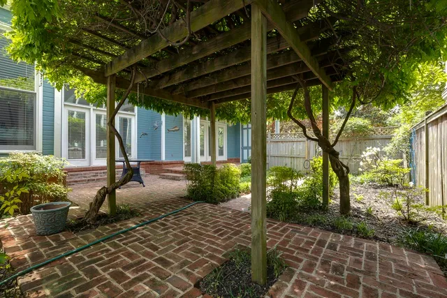 a view of a porch with furniture and garden