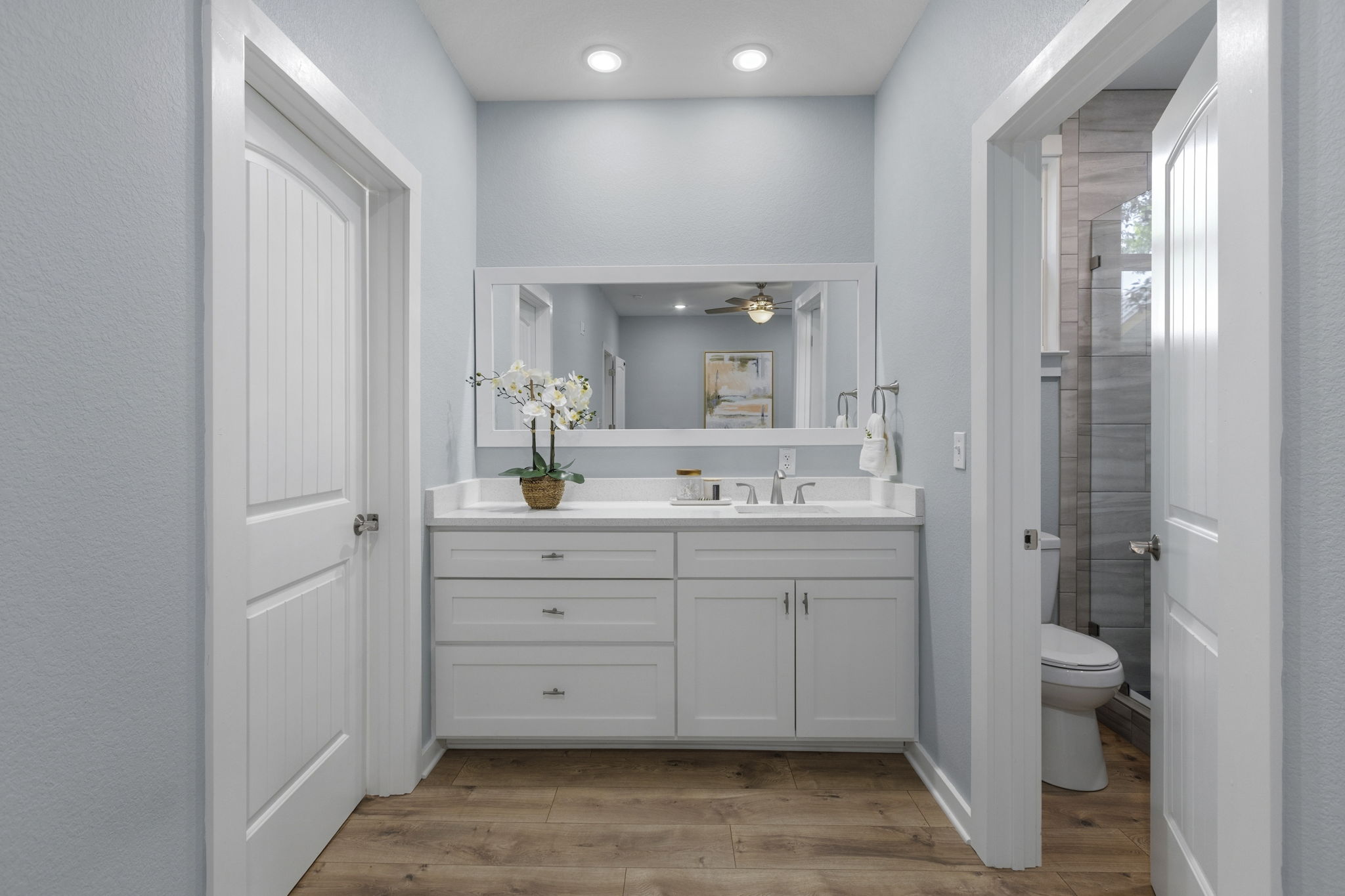 700 South Church Street Lockhart, TX 78644 - Photo 17 of 37 Primary vanity - Bathroom/shower to the right and walk-in closet to the left.