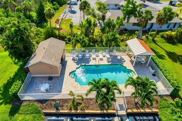 an aerial view of a house with a garden and trees