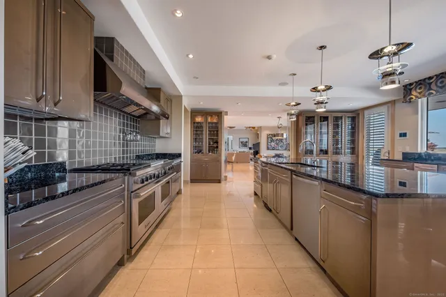 a large kitchen with stainless steel appliances lots of counter top space