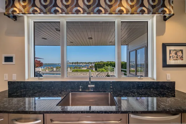 a kitchen sink with granite countertop a sink and a window