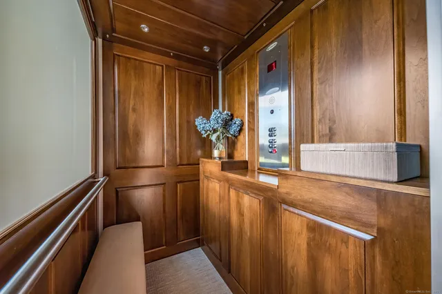 a hallway with sliding door and wooden floor