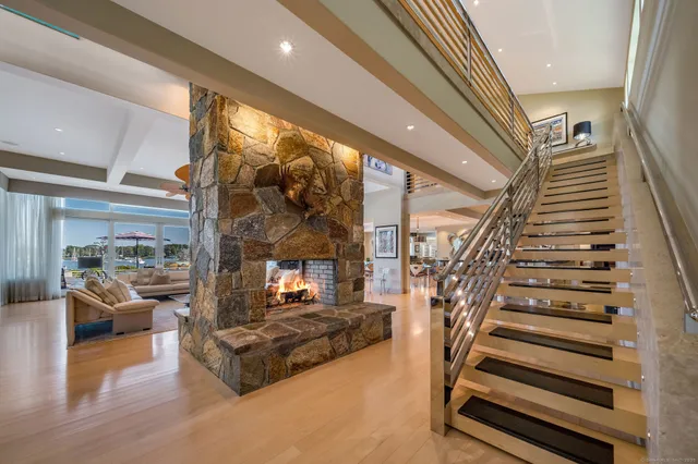 a living room with fireplace furniture and a wooden floor