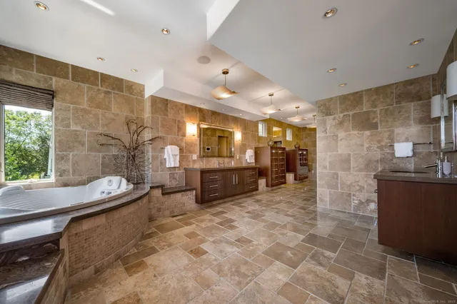 a large bathroom with a large mirror vanity and a shower