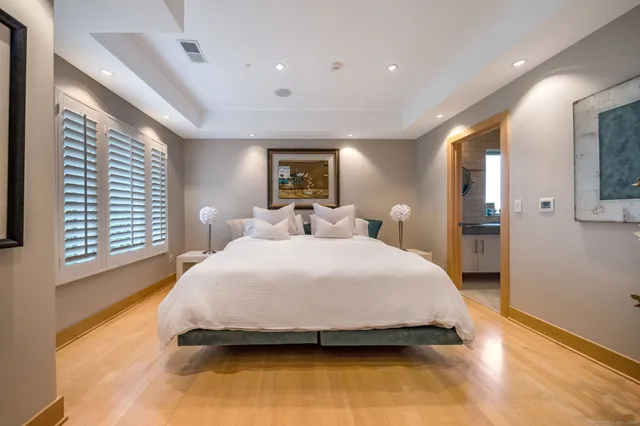 a spacious bedroom with a bed and a large window