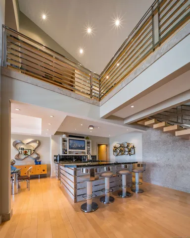 a kitchen with stainless steel appliances kitchen island granite countertop a sink and cabinets