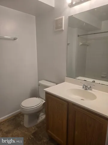 a bathroom with a sink toilet and a mirror