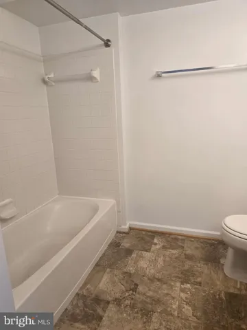 a bathroom with a bathtub and a toilet