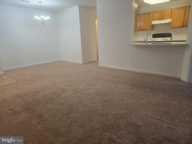 a view of kitchen and empty room
