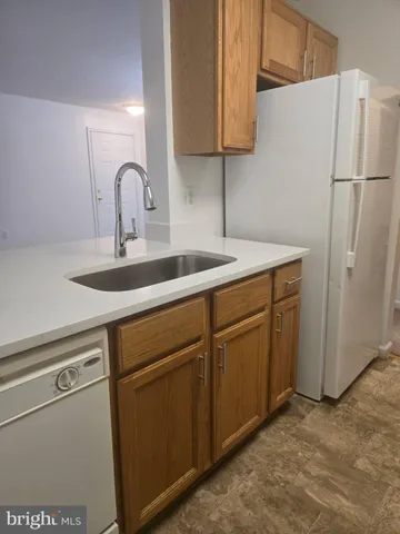 a kitchen with a sink cabinets and appliances
