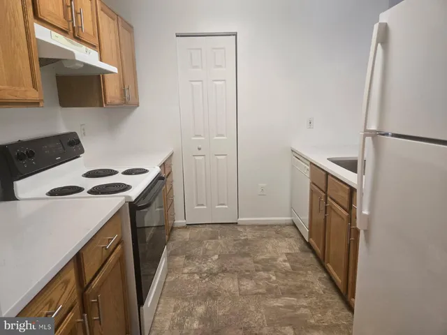 a kitchen with a stove a microwave and a refrigerator