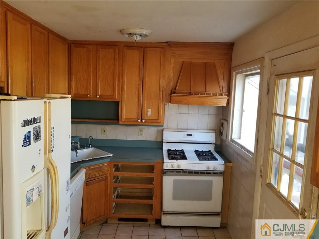 6 Rodney Road East Brunswick, NJ 08816 - Photo 4 of 15 a kitchen with stainless steel appliances granite countertop a refrigerator and a stove
