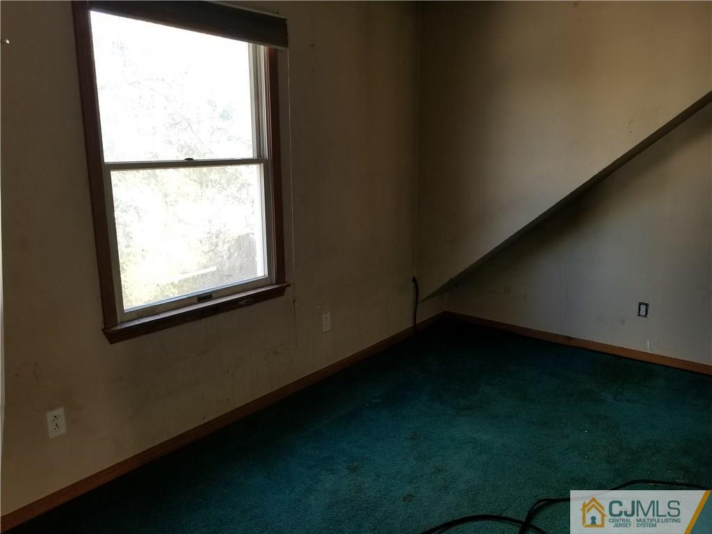 6 Rodney Road East Brunswick, NJ 08816 - Photo 9 of 15 a view of an empty room with a window