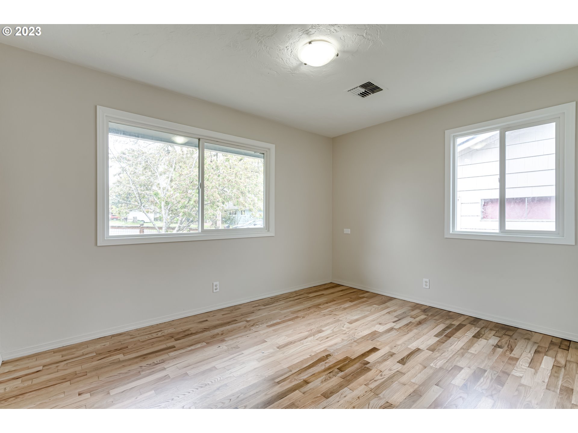 833 Elm Drive Eugene, OR 97404 - Photo 13 of 20 a view of an empty room with wooden floor and a window