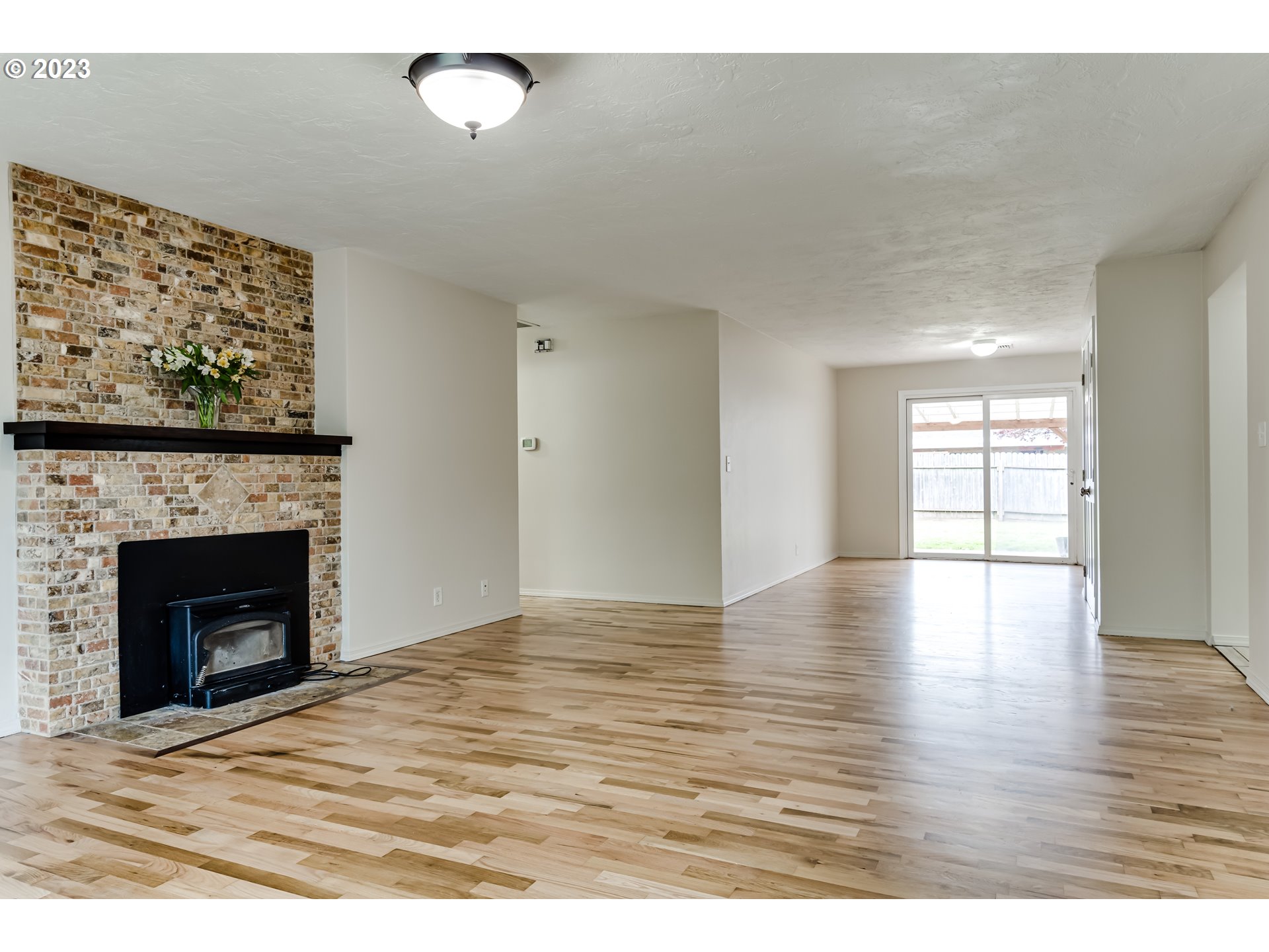 833 Elm Drive Eugene, OR 97404 - Photo 4 of 20 a view of empty room with wooden floor and fireplace