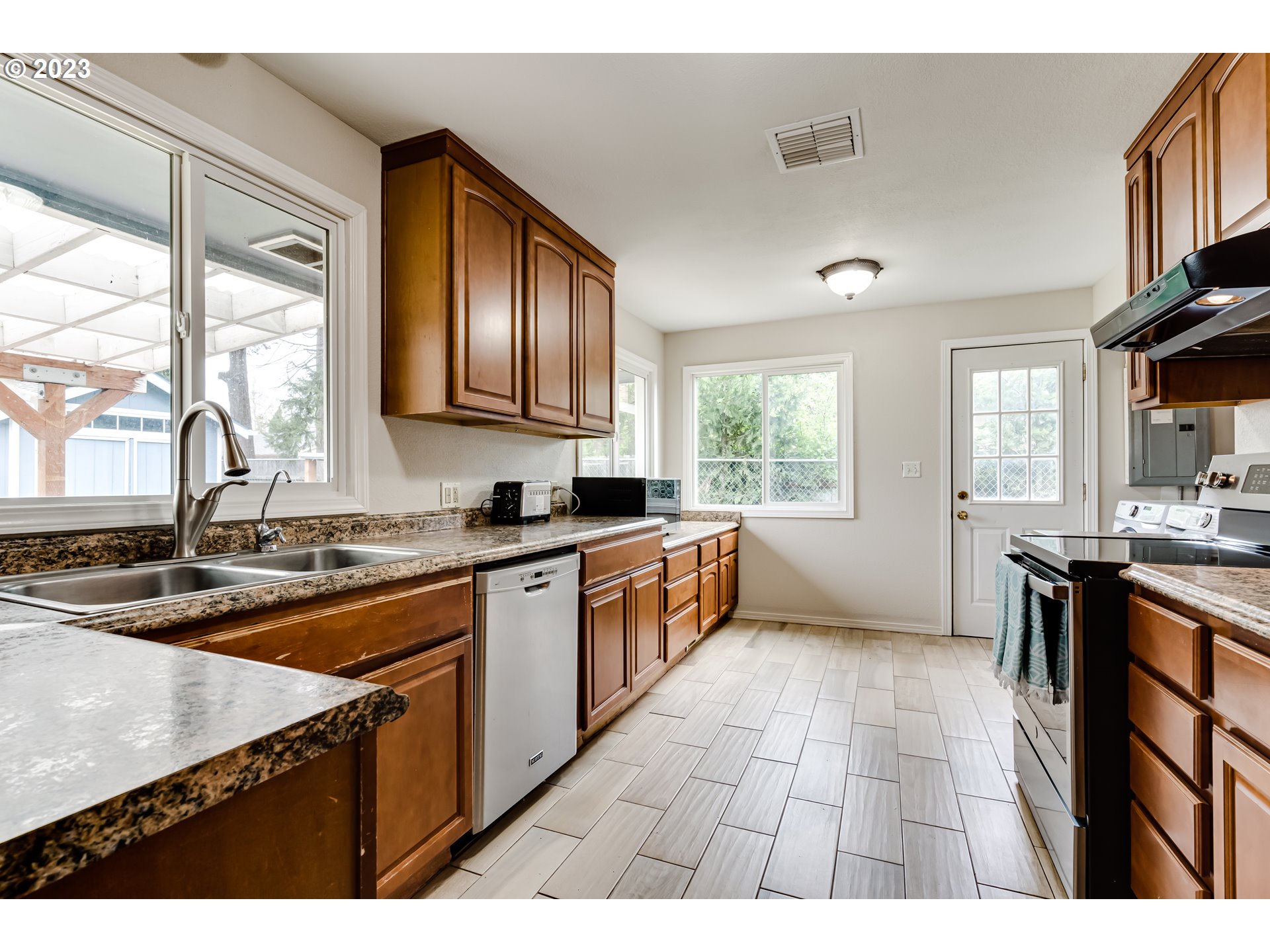 833 Elm Drive Eugene, OR 97404 - Photo 5 of 20 a kitchen with stainless steel appliances granite countertop a sink stove and cabinets