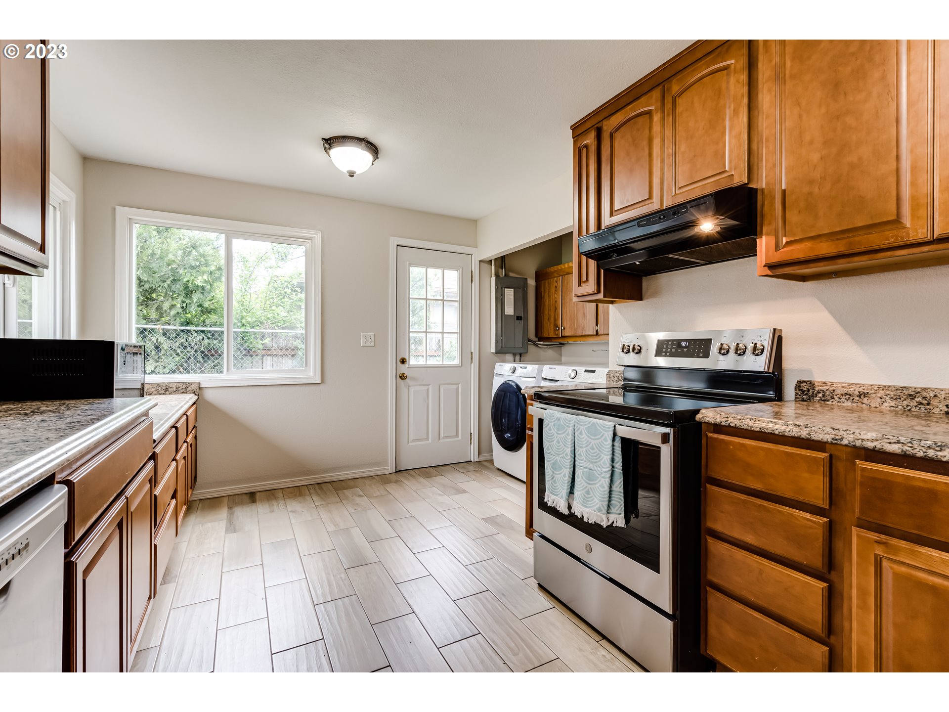 833 Elm Drive Eugene, OR 97404 - Photo 7 of 20 a kitchen with stainless steel appliances granite countertop a stove a sink and a microwave