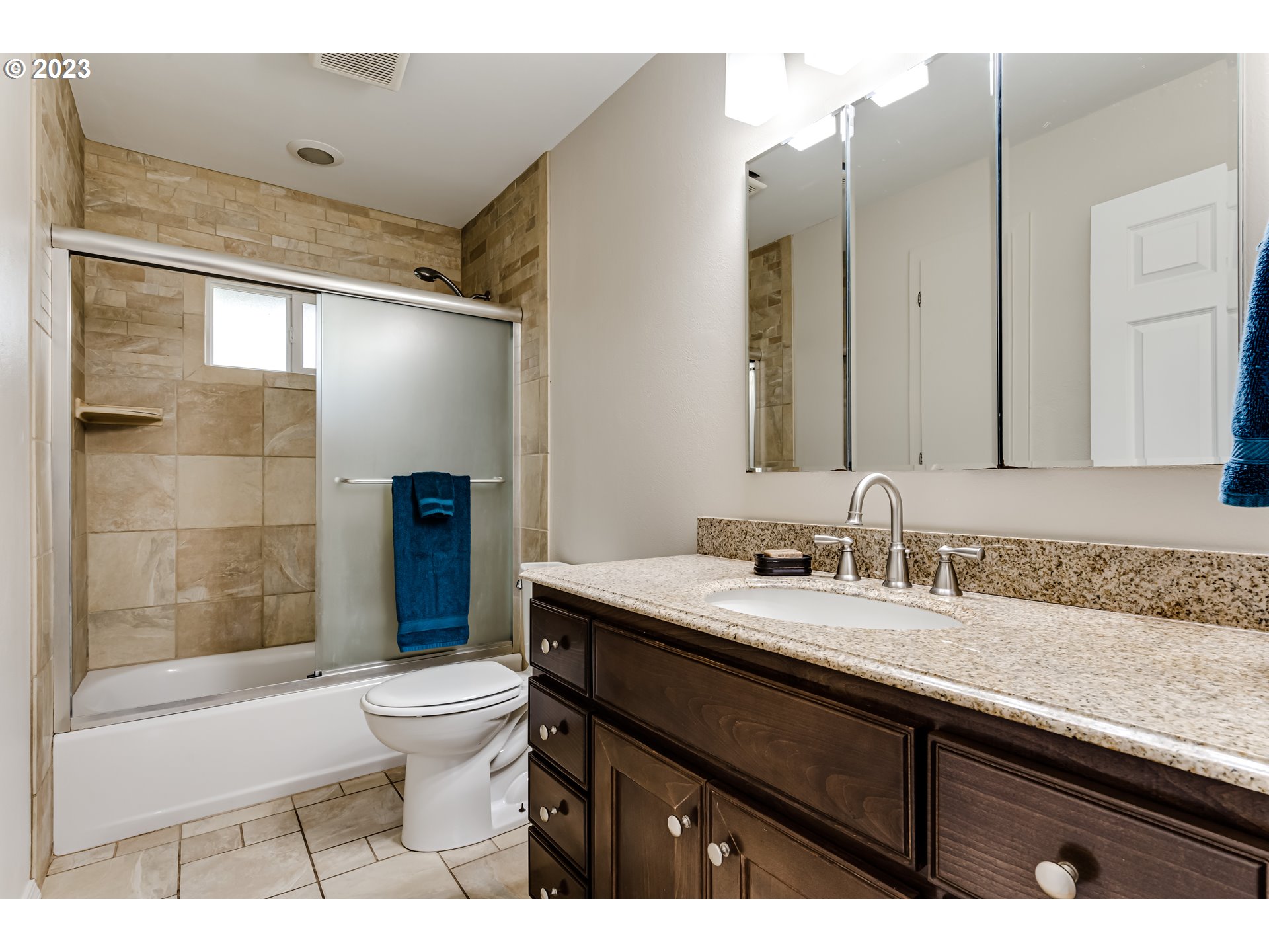 833 Elm Drive Eugene, OR 97404 - Photo 9 of 20 a bathroom with a granite countertop sink toilet a mirror and shower