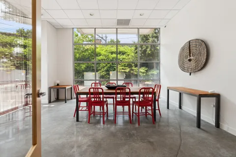 a dining room with furniture and a large window
