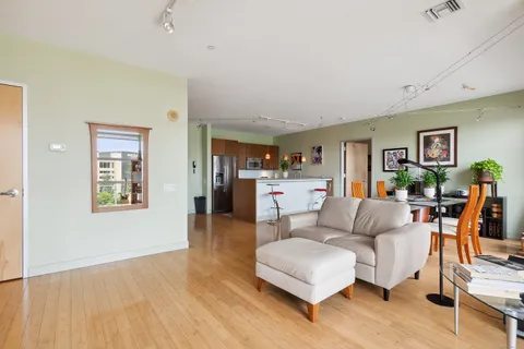 a living room with furniture and a wooden floor