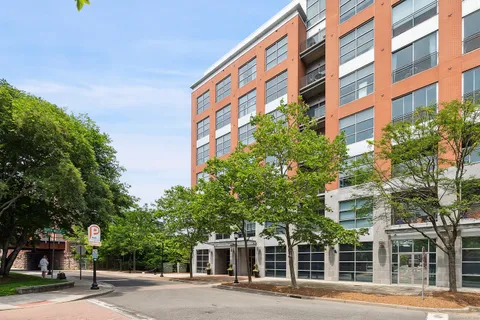 a front view of a multi story building with a yard