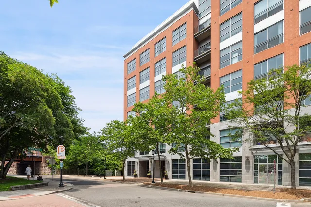 a front view of a multi story building with a yard