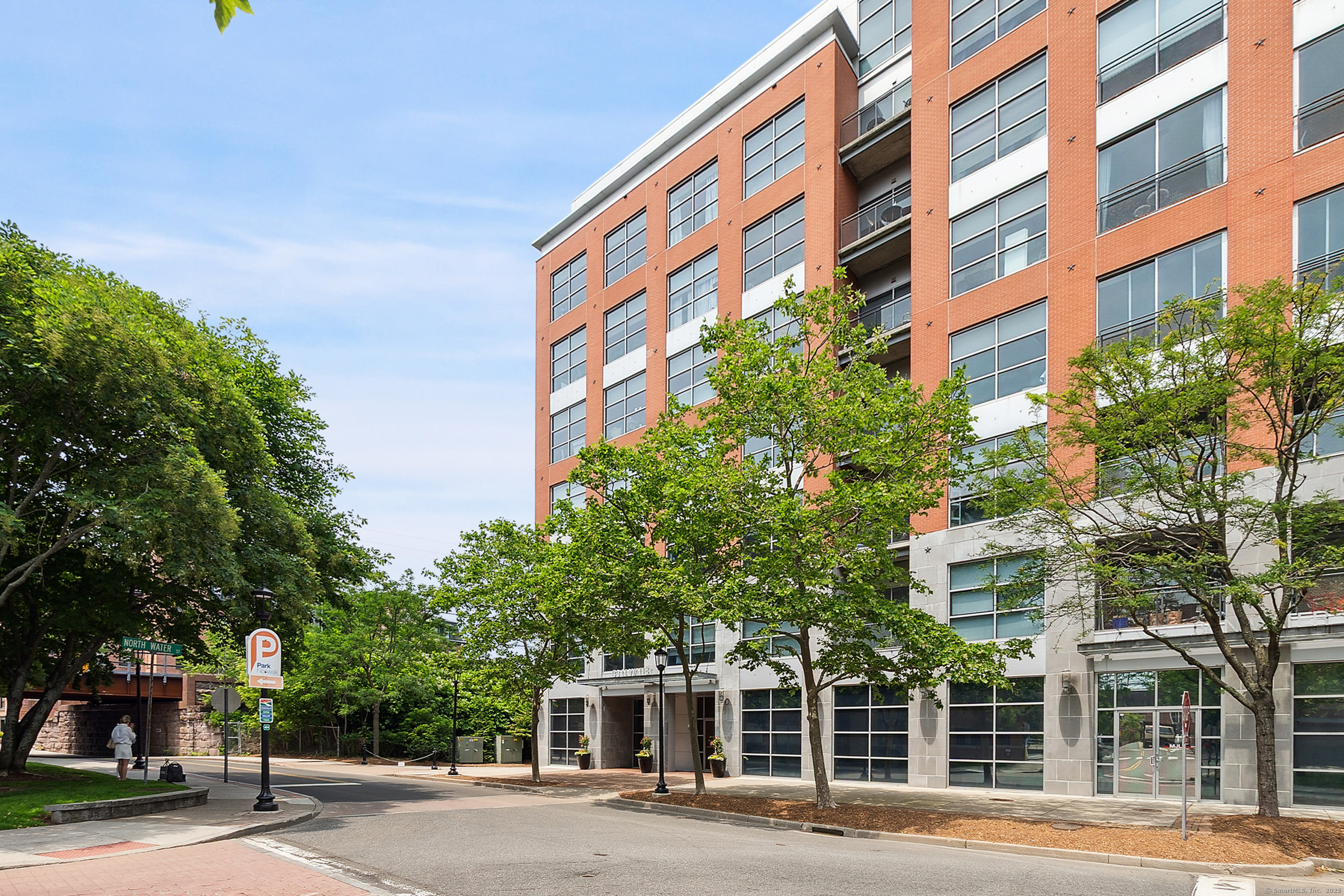 33 North Water Street, Unit 505 Norwalk, CT 06854 - Photo 24 of 25 a front view of a multi story building with a yard