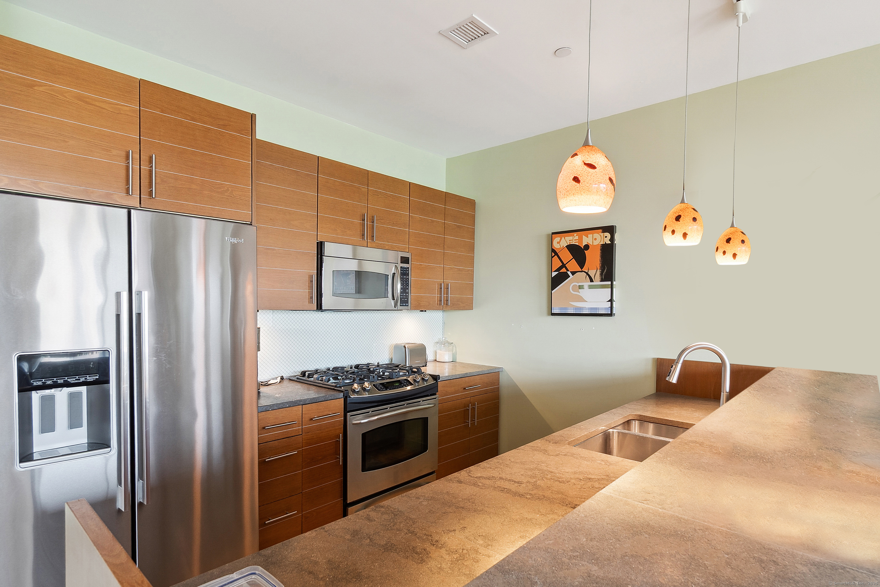 33 North Water Street, Unit 505 Norwalk, CT 06854 - Photo 3 of 25 a kitchen with stainless steel appliances granite countertop a refrigerator and a stove top oven