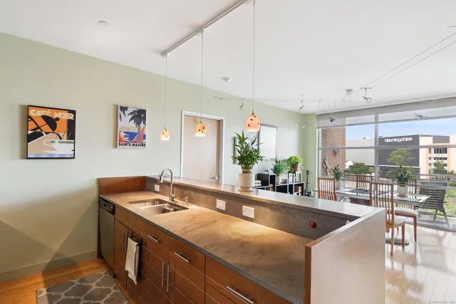 a kitchen with stainless steel appliances a sink and a large window