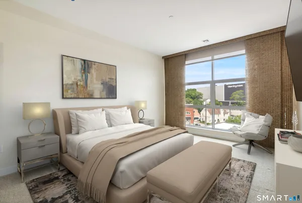 a bedroom with a bed and a large window