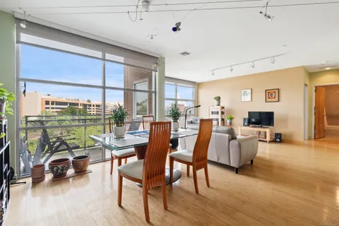 a living room with couches a coffee table and a large window with garden view
