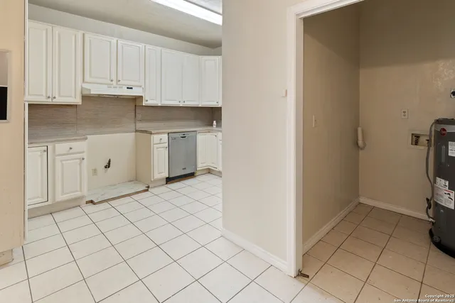 a kitchen with white cabinets