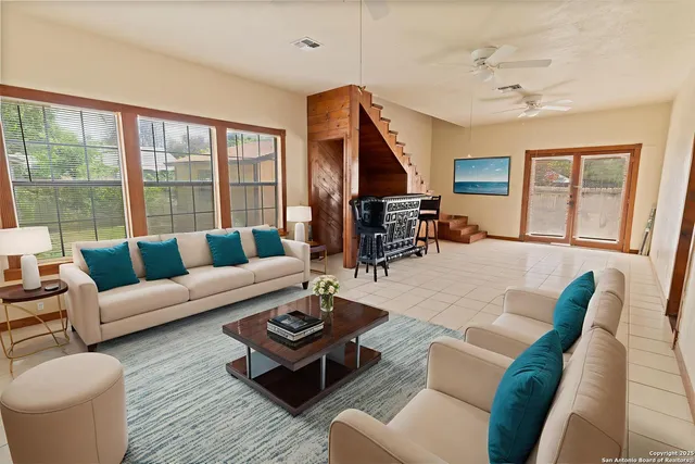 a living room with furniture fireplace and a large window