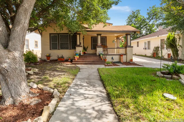 a front view of a house with a yard table and chairs