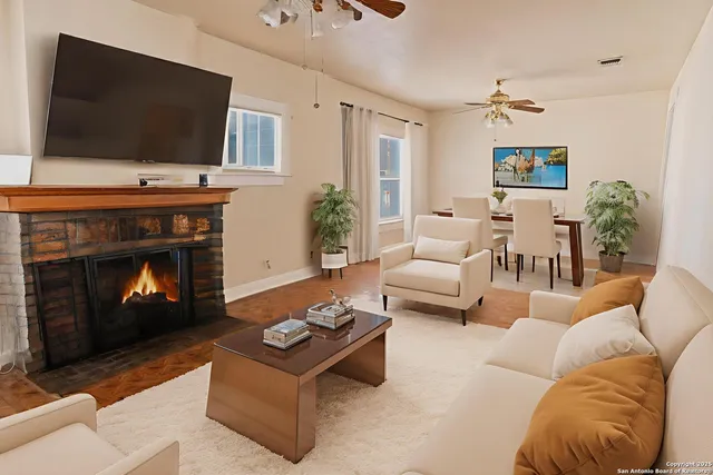 a living room with furniture a flat screen tv and a fireplace