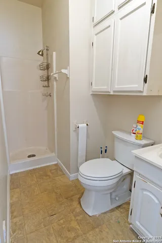 a bathroom with a toilet a sink and a shower