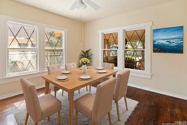 a view of a dining room with furniture large windows and wooden floor
