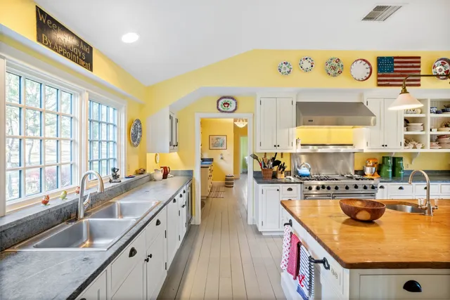 a kitchen with a stove a sink and a refrigerator