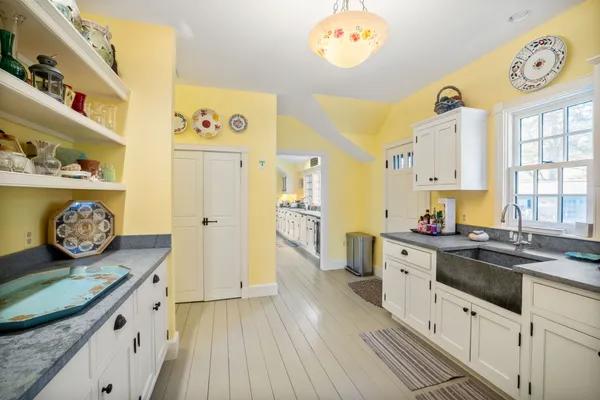a kitchen with a sink a stove and cabinets