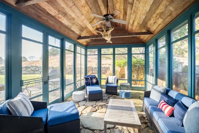 a living room with furniture and floor to ceiling windows