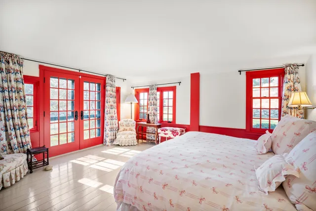 a bedroom with a bed and a large window