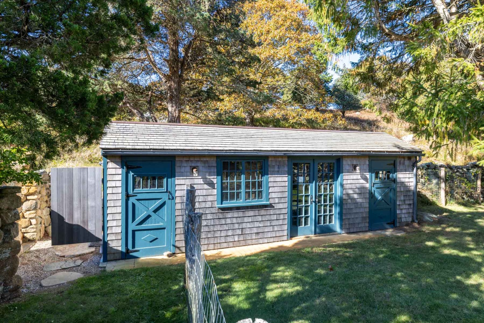 85 North Reservoir Road Vineyard Haven, MA 02568 - Photo 36 of 42 a view of a house with a small yard and a large tree