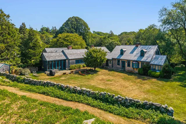 an aerial view of a house with swimming pool garden and patio