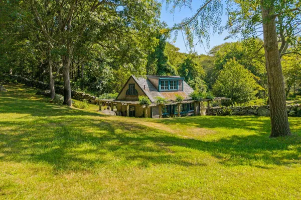 a front view of a house with yard and green space