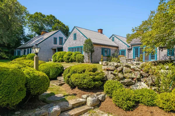 a front view of house with yard and green space