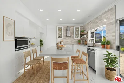 a view of a room with window and ceiling fan